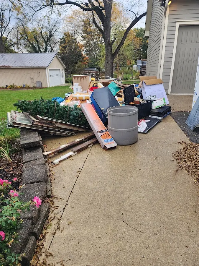Dumpster being loaded with debris for Commercial Dumpster Rental in Shaw Heights